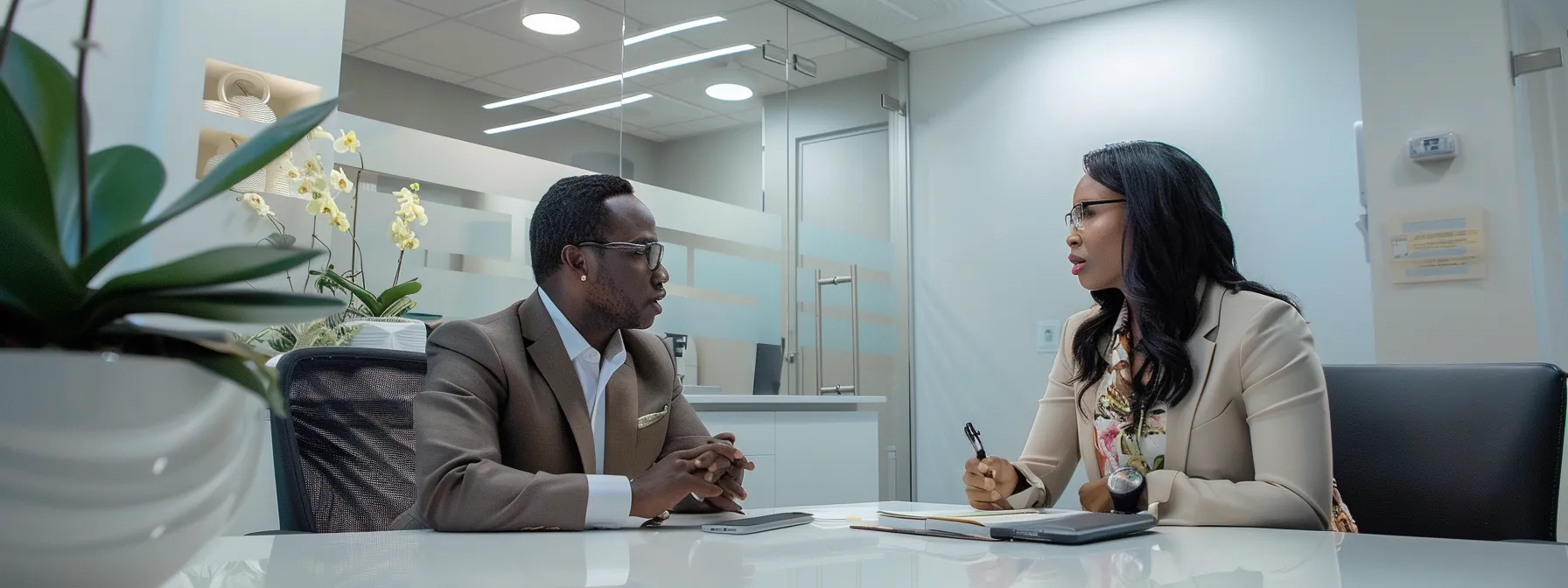 a contemporary immigration law office features a confident attorney engaged in a focused discussion with a diverse client, illuminated by sleek overhead lighting that enhances the professionalism of the space.